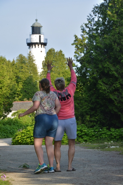 beck and madi on the path to a lighthouse